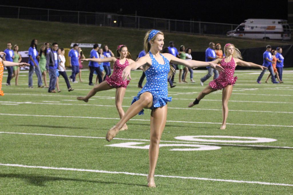 On the football field:  Senior Laynie Hardisty prepares for a turn. She will be dansing at the show-offs in the officers dance