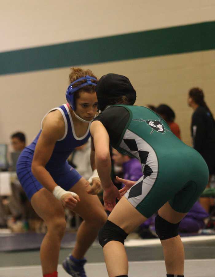 Searching for the take down: Junior Mariah Mack positions herself to take down her opponent. Photo by Skylar Campbell.