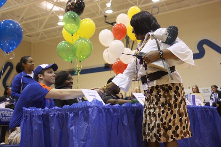 Congratulations are in order: Assistant Principal Valorie Mason shakes hands with senior Cole Barbe after his signing with Houston Baptist University. Photo by Dairyn Salguero