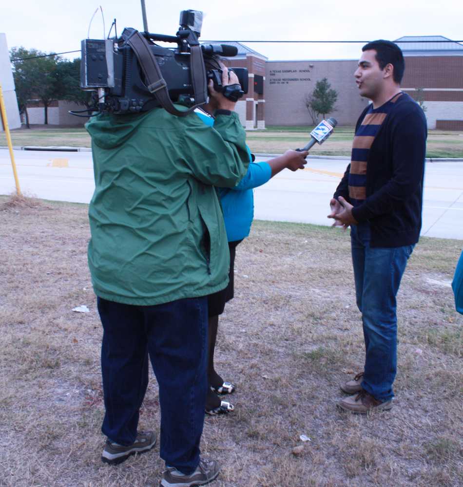 LIghts,  camera, action: A news reporter asks senior Victor Garibaldi about the gun incidents. Garibaldi said he thought Cy Creek was a safe campus. photo by Kristin Russell.