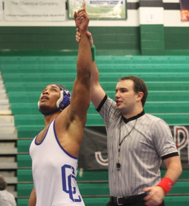 And the winner is...: Senior Isaac Johnson takes on the title of regional champion for the 220-pound weight class. Photo by Skylar Campbell.