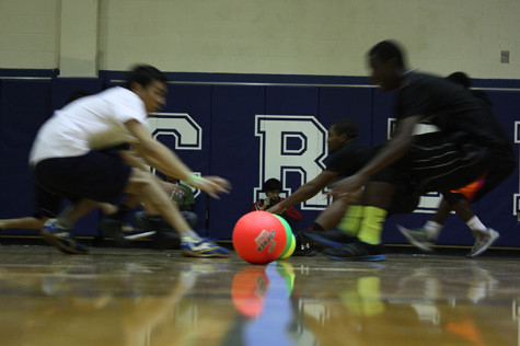 Competitors rush to pick up dodgeballs.