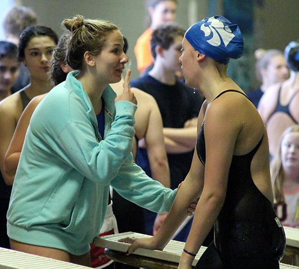 Senior Annie Eubanks congratulates Sophomore Tara Howard on her swim in the 200m medley relay. The girls placed second in the event.
