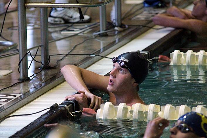 Sophomore Todd Coachman finishes the 200m freestyle. He placed fourth overall.