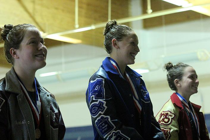 Senior Tori Karker on the podium after winning first in the 200m freestyle.