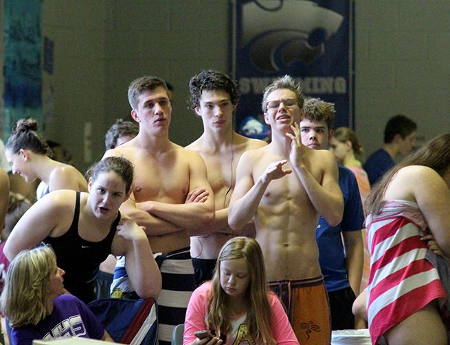 Junior Braxton Flowers and Seniors Sam Shorr, Damian Wilkerson and Chance Morris cheer on their teammates.