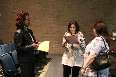 Leggio passes out dual credit and advanced placement forms to parents who attended the college credit meeting.