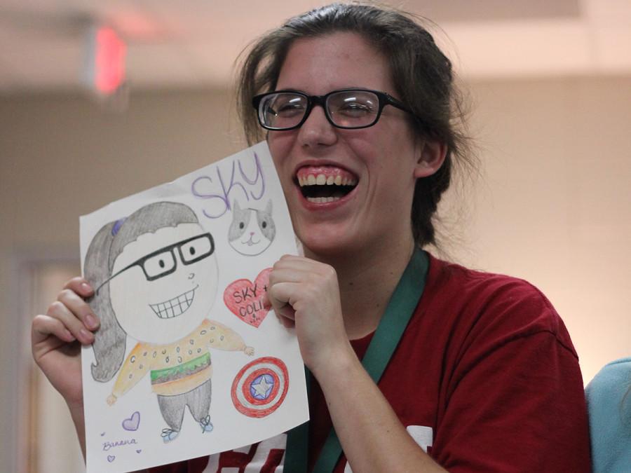 Senior Skylar Campbell holds up a drawing of herself, given to her as a secret Santa gift. 