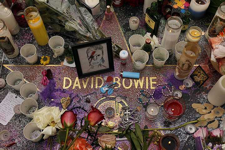 With David Bowie music blasting from speakers fans place memorabilia at a growing memorial for rock star David Bowie at his star on the Walk of Fame on Jan. 11, 2016 located on Hollywood Blvd in Hollywood, Calif (Al Seib/Los Angeles Times/TNS)