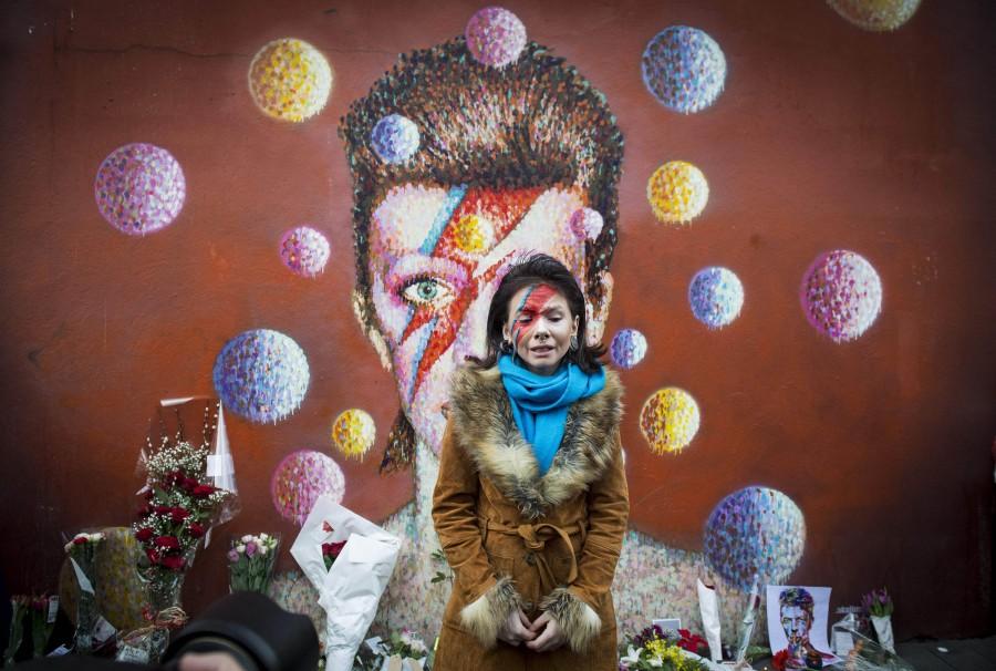 A fan visits the mural of David Bowie in Brixton where the star grew up, to pay her respects, on Jan. 11, 2016 in London. (Ben Stevens/i-Images/Zuma Press/TNS)