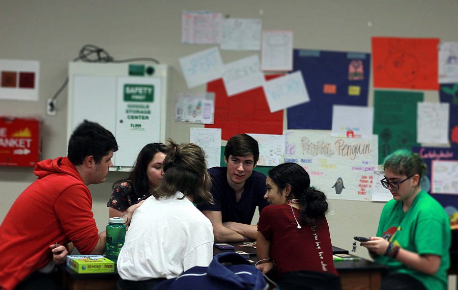 Club members gather around to discuss club activities