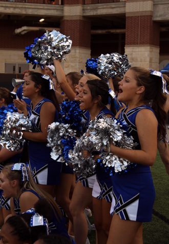 Cheerleaders yell in support of the boys in blue.