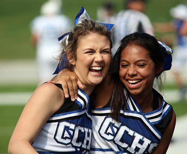 Cheerleaders celebrate during the final football game of the season.