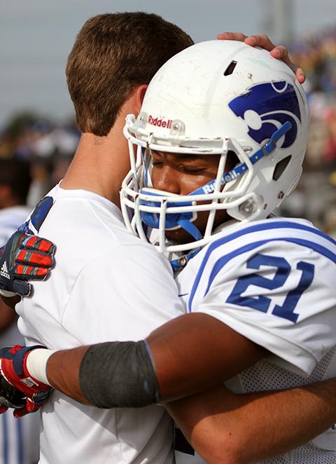 Senior Kaleb OBryant hugs senior Bryce Davidson after the end of the final football game.