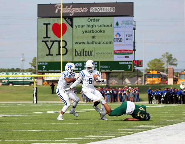 Junior Miles battle runs downfield aided by senior Ryan Nealy. 