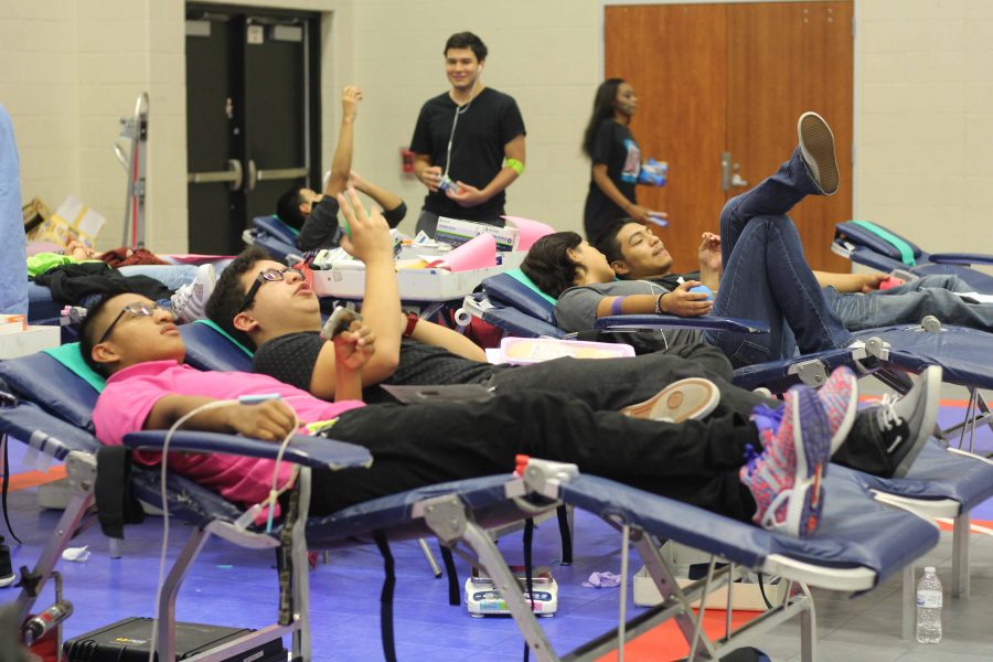 Students giving blood at the school blood drive