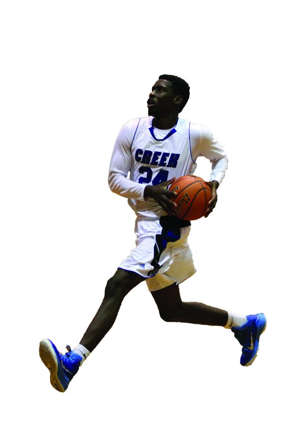 Junior Varsity forward Eric Harris, 11, strides for two easy points for the Cougar basketball team.