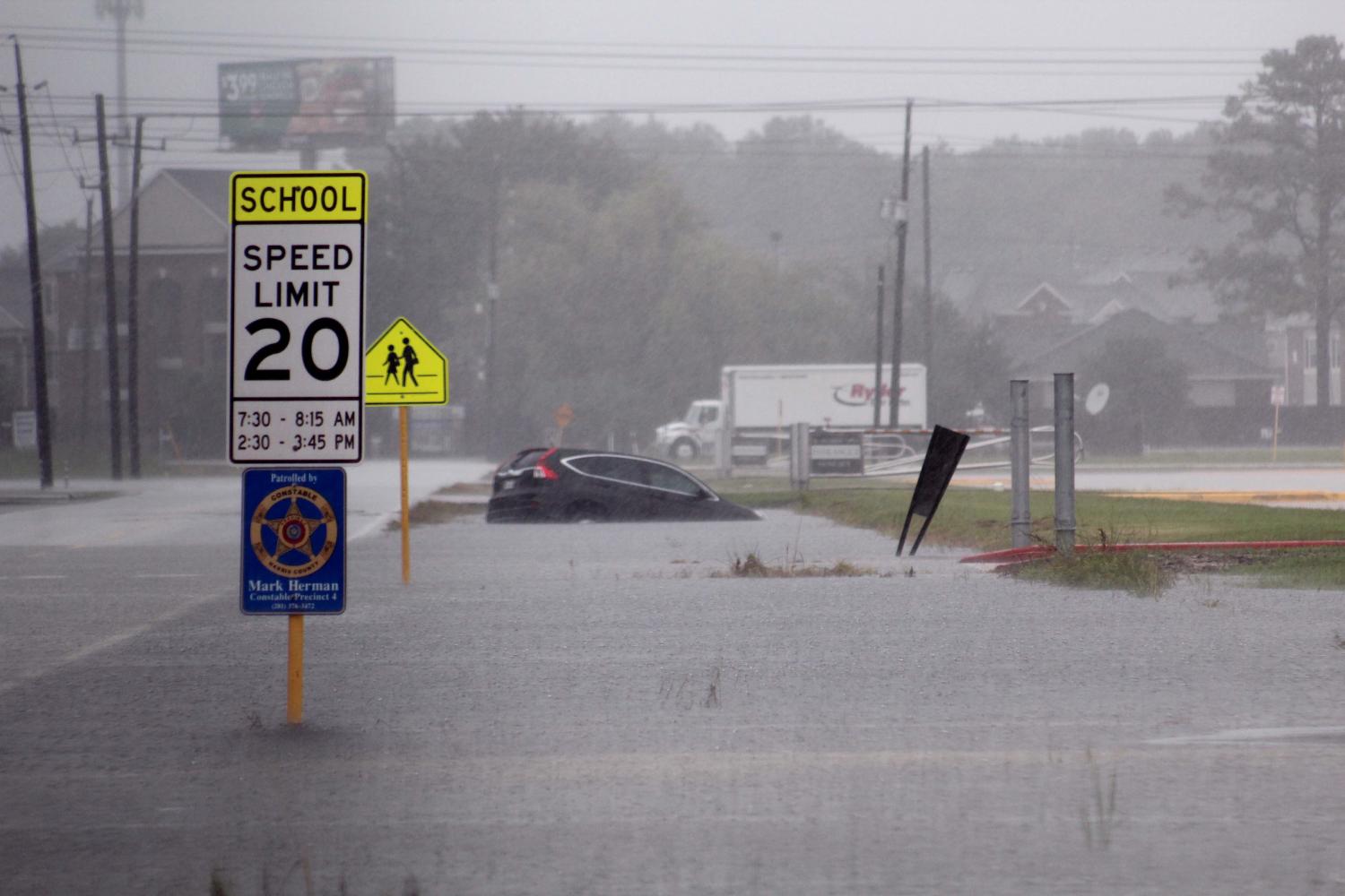A car is stranded by flood waters.
