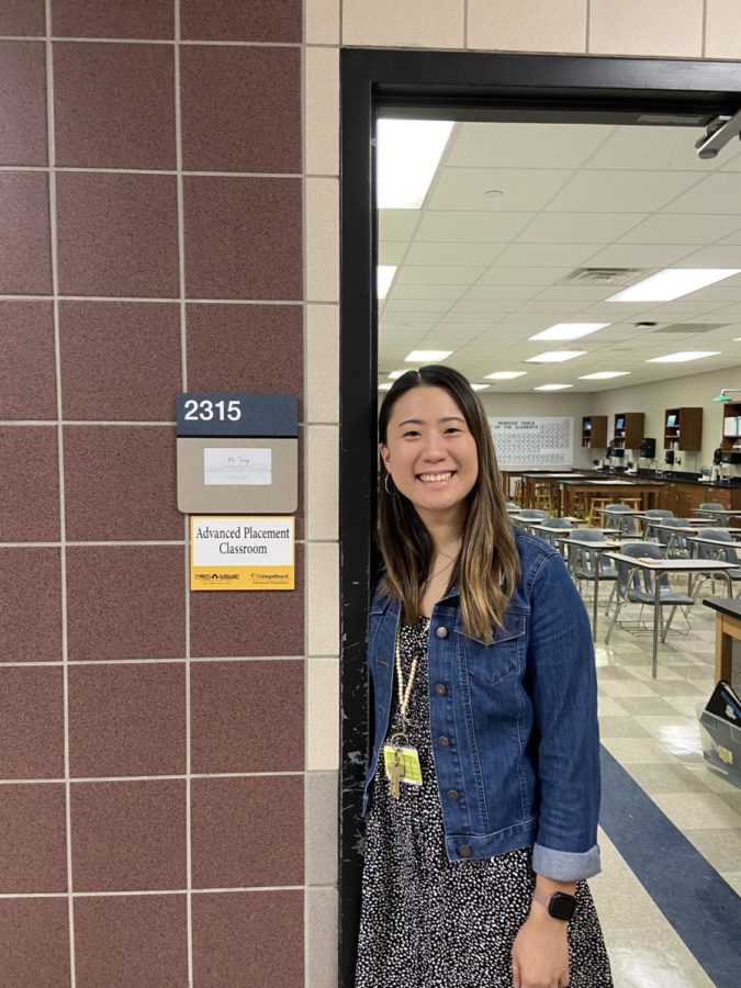 Tang pictured in the door frame in front of her classroom.