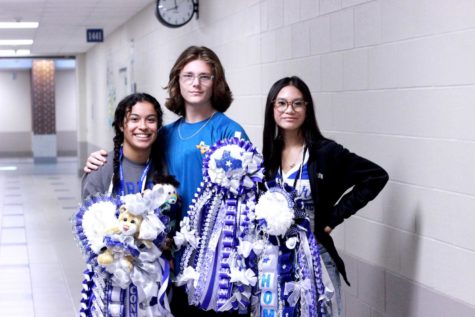 Junior Samantha Paz, senior Connell Martin, and junior Lillian Taylor pose in their Homecoming mums on Friday, Oct. 14, 2022. Photo by Cougar Pride staff.