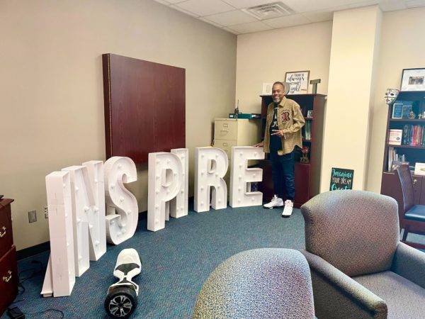 Principal Martin Drayton poses beside his action word for the year - inspire - inside the admin suite. 